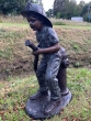 Bronzeskulptur Kleiner Junge Sam als Feuerwehrmann im Garten 
