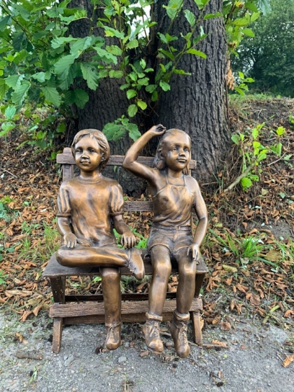 Bronzeskulptur Erik und Sophie auf einer Bank mit brauner Patina von vorne